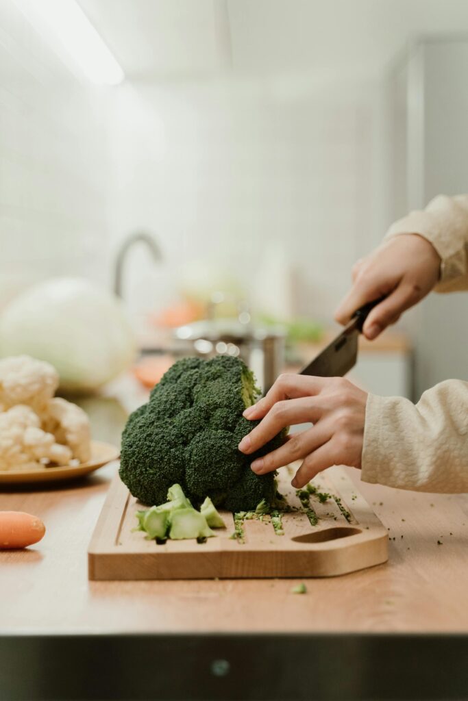 Close-Up Shot of Person Cutting a Broccoli